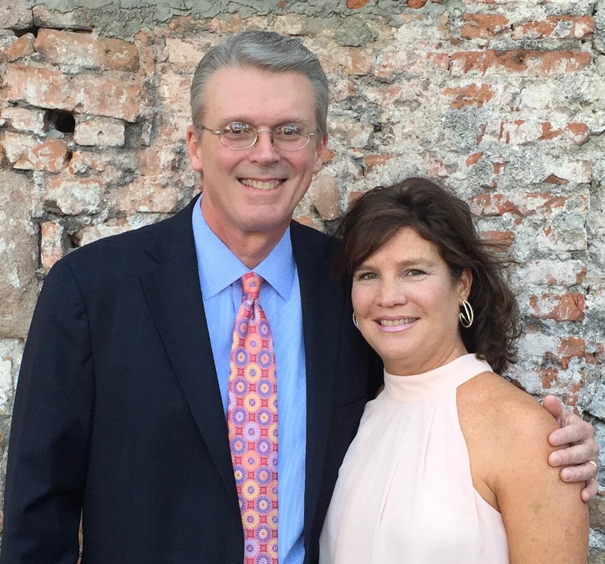 Phil Buffington and his wife Sarah standing in front of an old brick wall