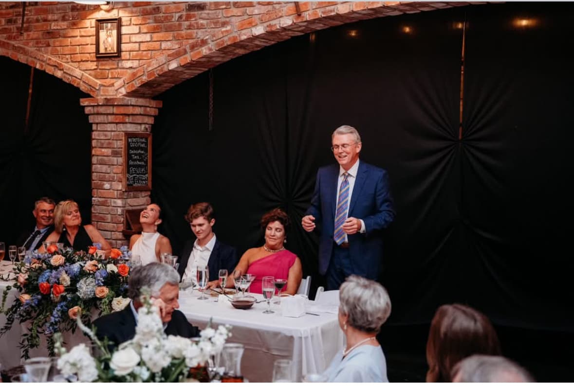 Phil Buffington standing and speaking to guests at a dinner